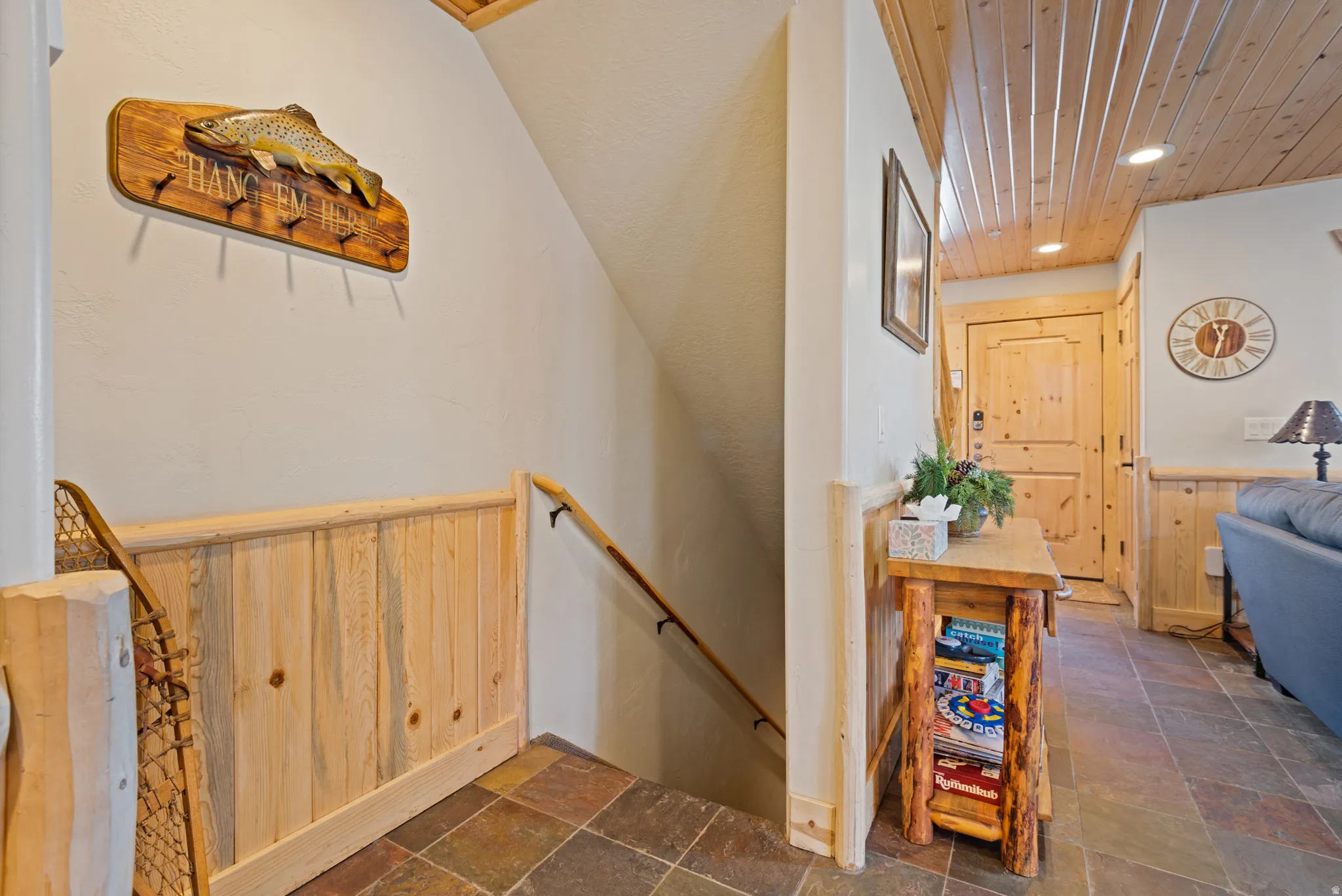 Entryway featuring slate tile flooring, natural wood wainscoting, and a wood-paneled ceiling with recessed lighting