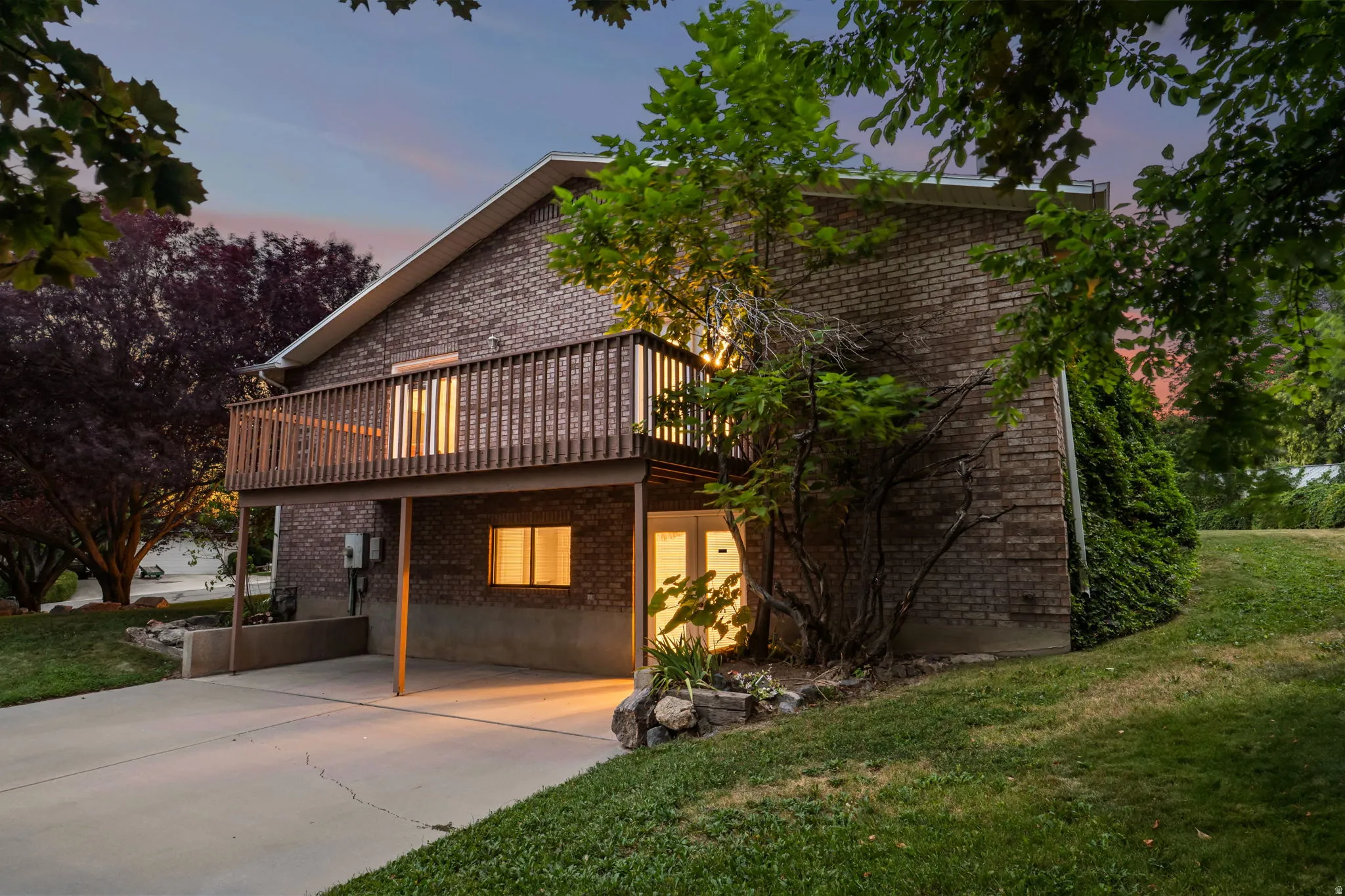 Brick exterior with a second-story wooden deck