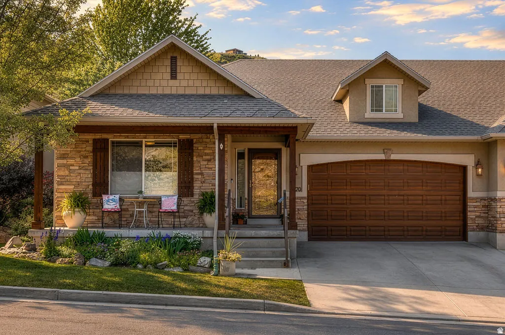 Stone and stucco exterior with a prominent front porch