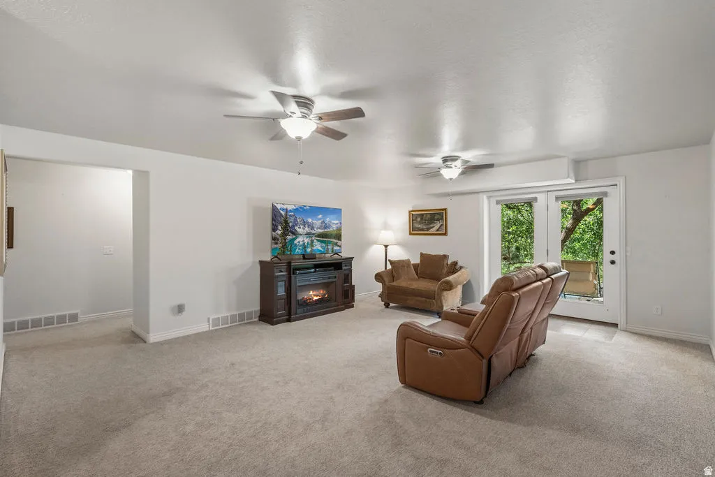 Spacious room featuring light-colored carpeting and white walls