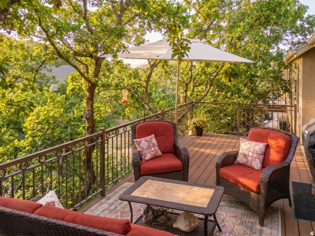 Spacious outdoor deck featuring composite decking and an ornate metal railing
