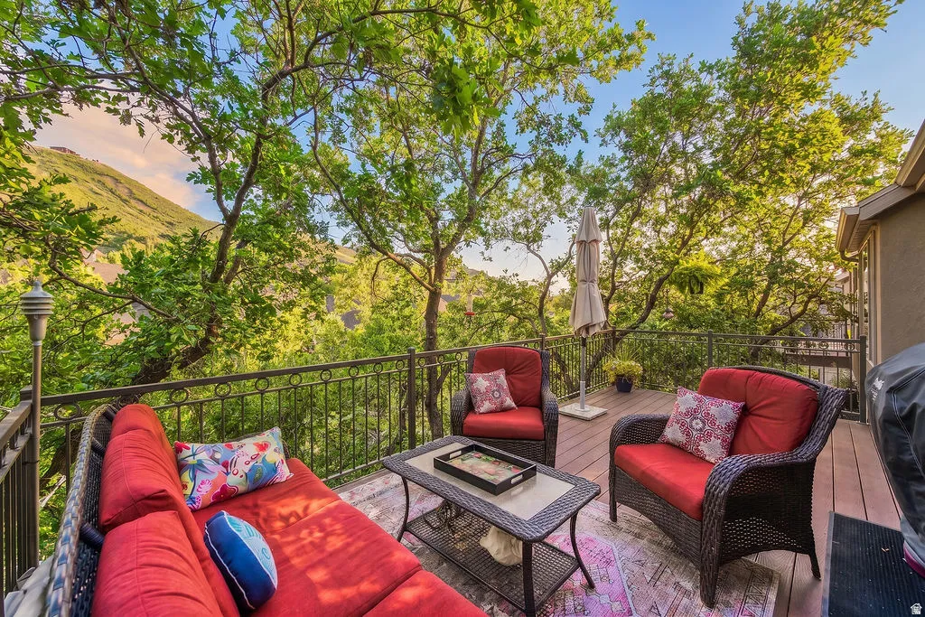 Expansive outdoor deck featuring wood-finish flooring and a wrought-iron railing