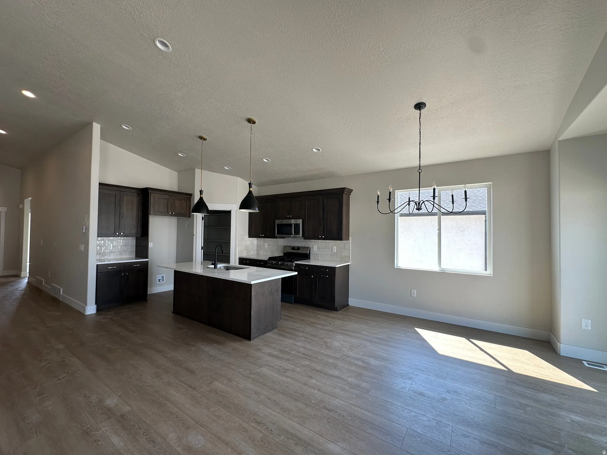 Open-concept living space with wood-finish flooring