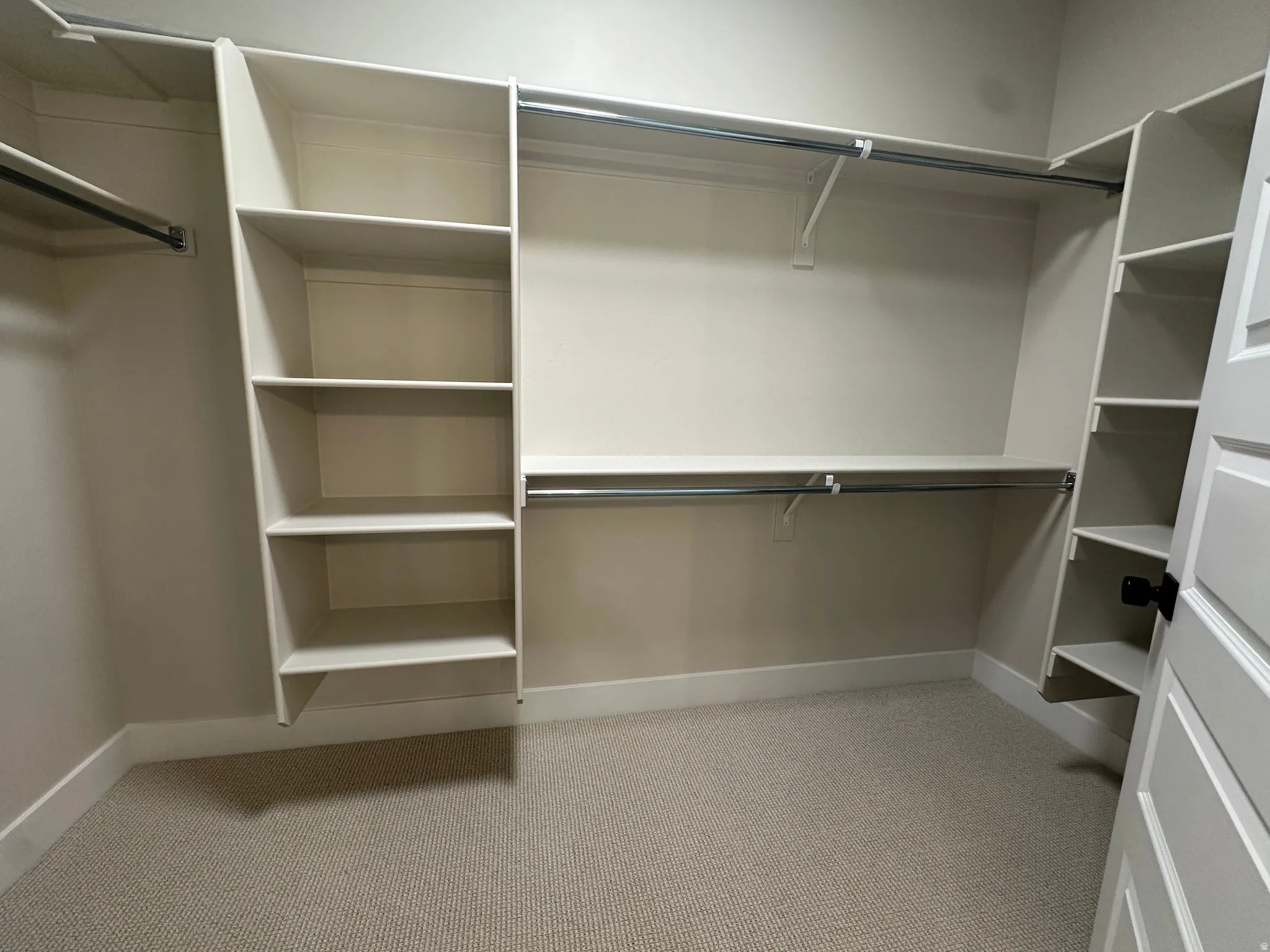 Built-in shelving, hanging rods, and light-toned walls