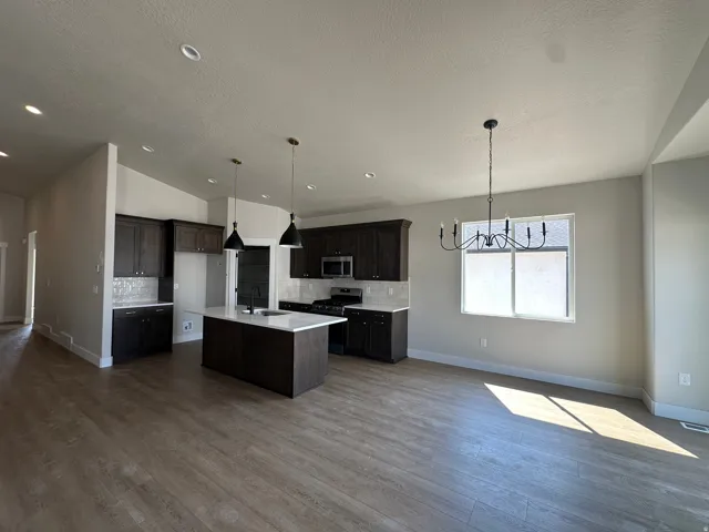 Open-concept living space with wood-finish flooring
