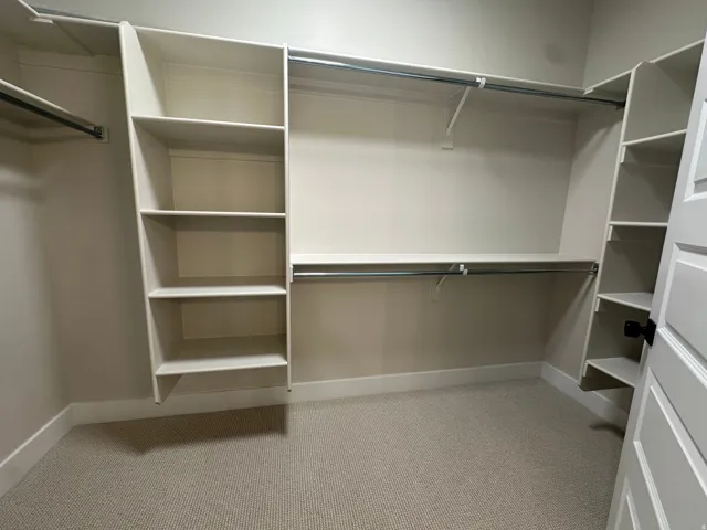 Built-in shelving, hanging rods, and light-toned walls