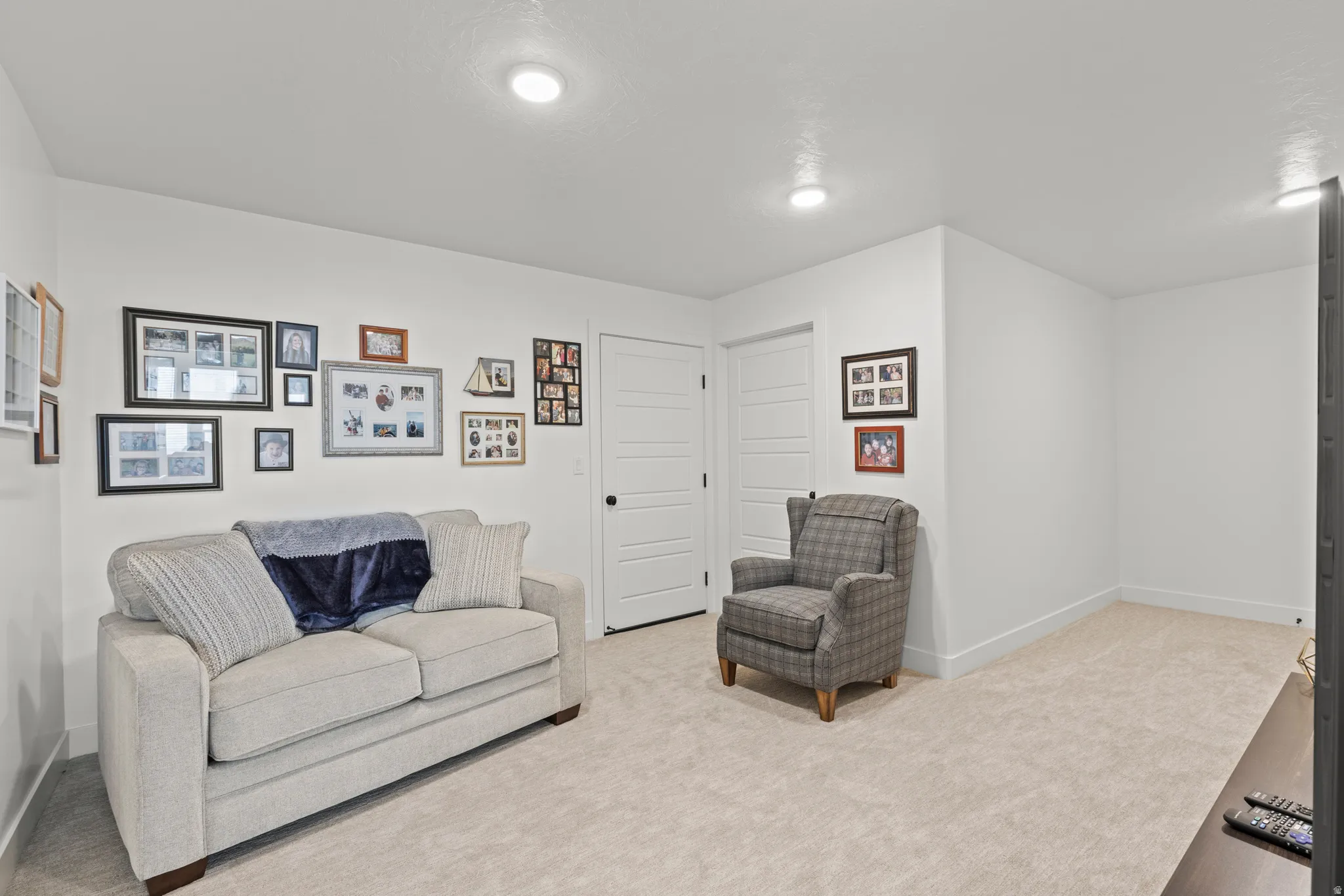 Neutral-toned wall-to-wall carpeting complements bright white walls and trim
