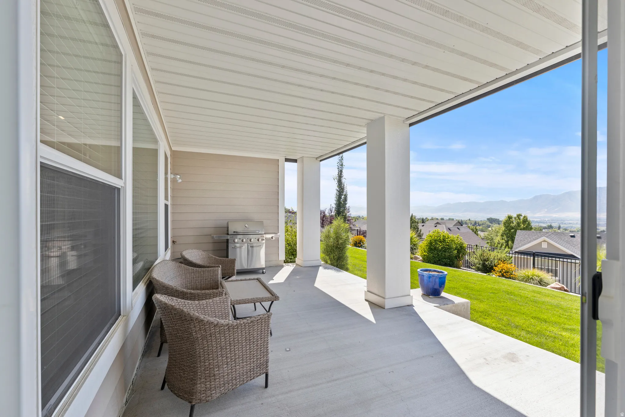 Covered patio with a concrete surface and substantial support columns