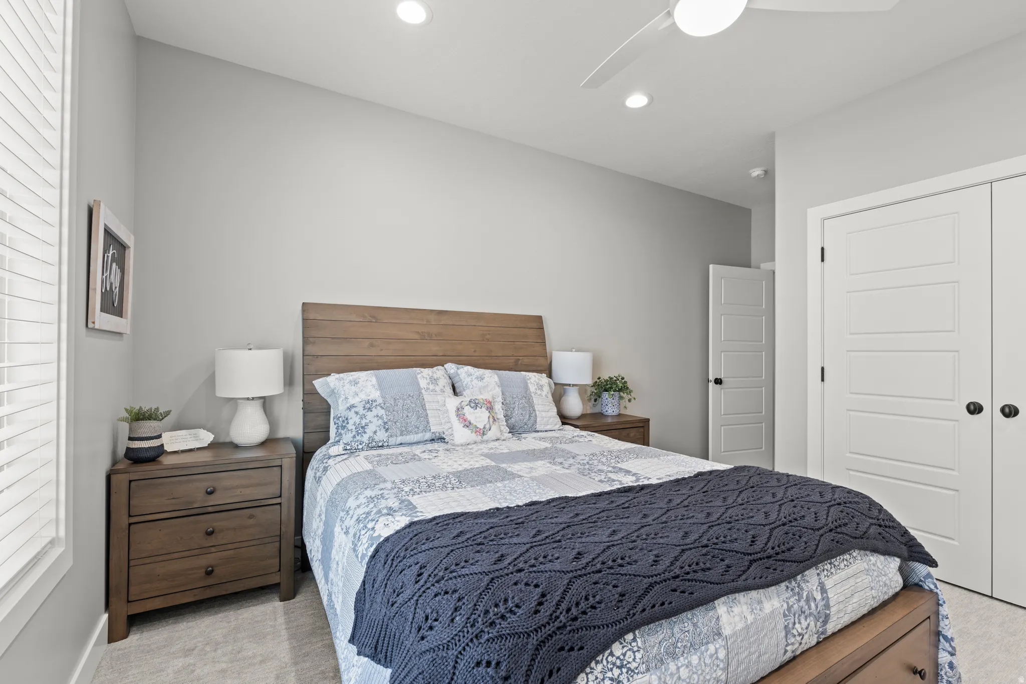 Bedroom featuring a wood-finish bed frame and headboard, recessed lighting, and a contemporary ceiling fan