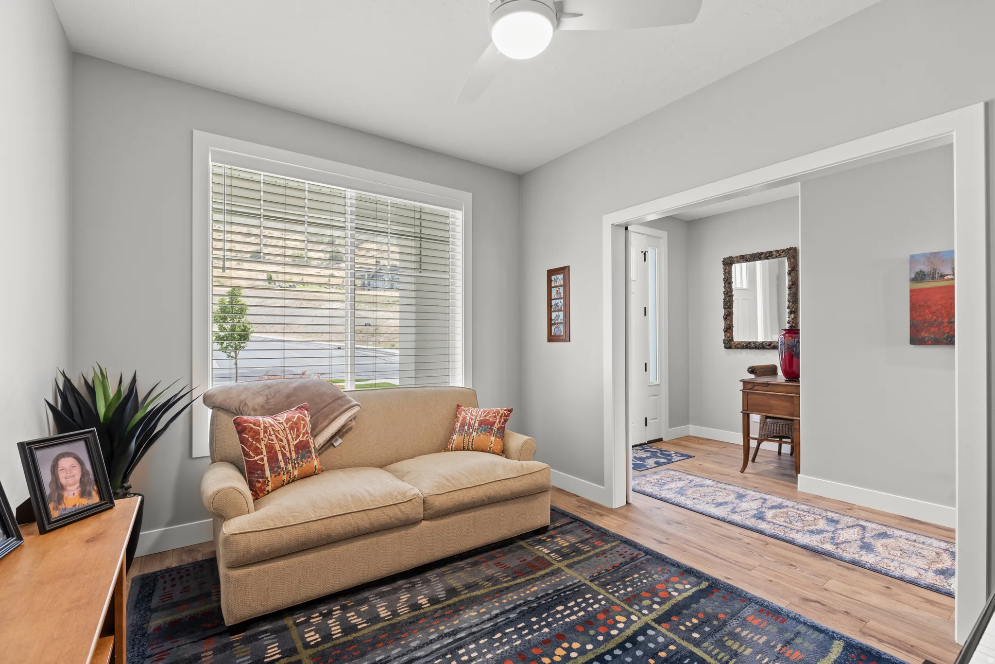 Bright interior space featuring light gray walls and wood-finish flooring