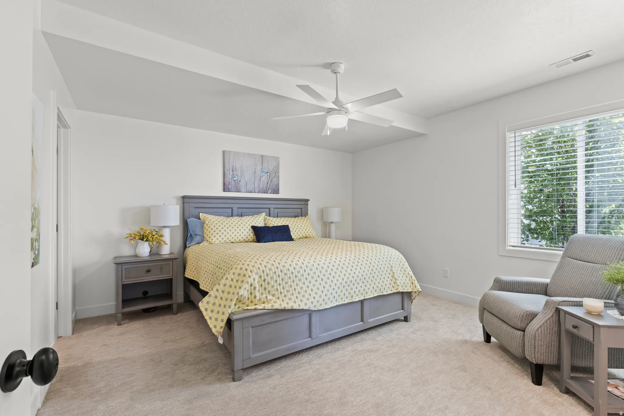 Carpeted room featuring a ceiling fan, recessed lighting, and a large window with blinds
