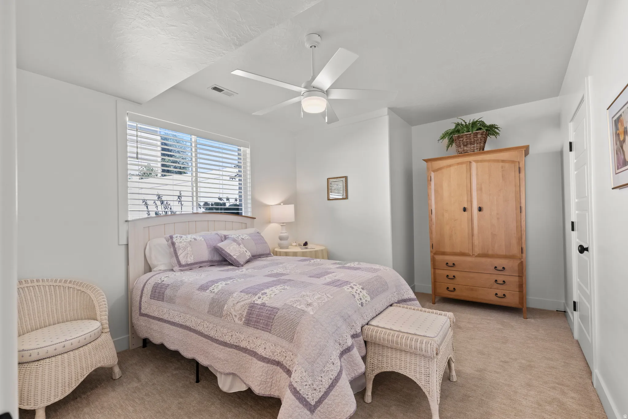 Carpeted room featuring a ceiling fan, white window blinds, and white trim