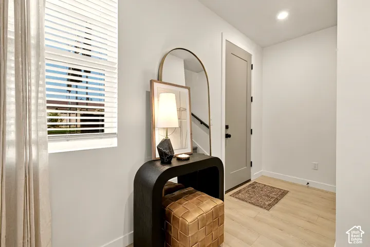 Entryway featuring light-toned wood-finish flooring, recessed lighting, and a neutral-colored interior door with matte black hardware and hinges