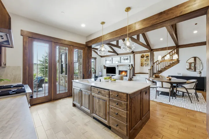 Kitchen island with integrated sink and brass pendant lighting
