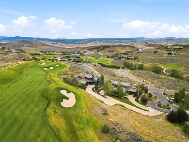 Expansive golf course property featuring manicured greens and sand traps