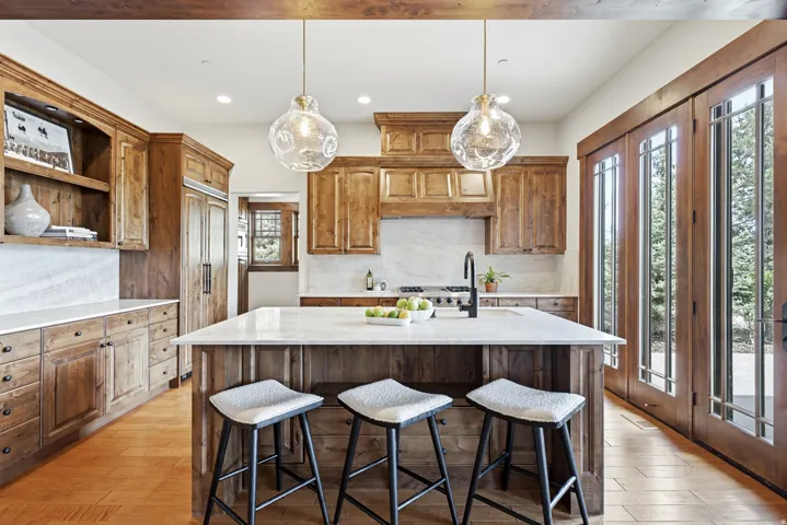 Central island with a light-toned countertop and wood-finish paneling