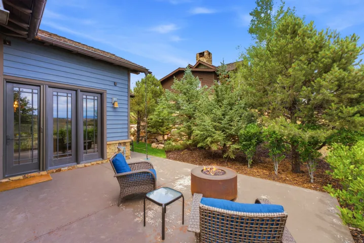 Outdoor patio area featuring a concrete surface and a built-in fire pit