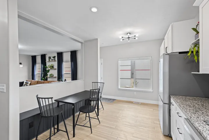 Kitchen and dining area featuring light wood-finish flooring