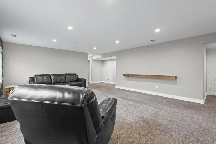 Spacious room featuring neutral carpeting and light gray walls