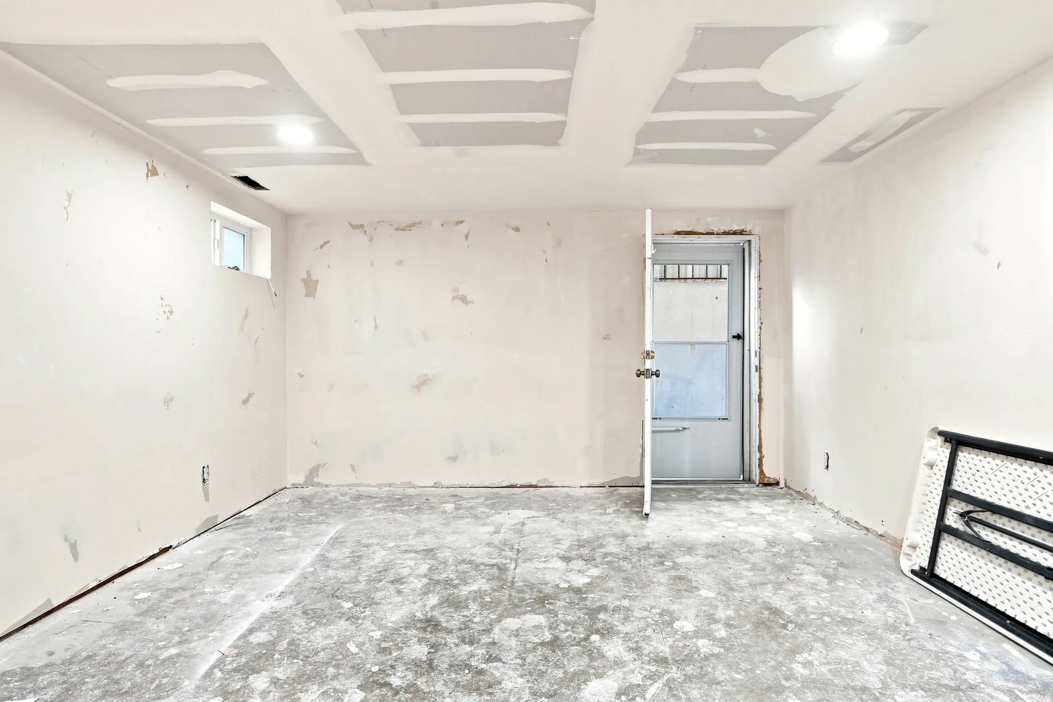 Unfinished interior space with exposed concrete flooring