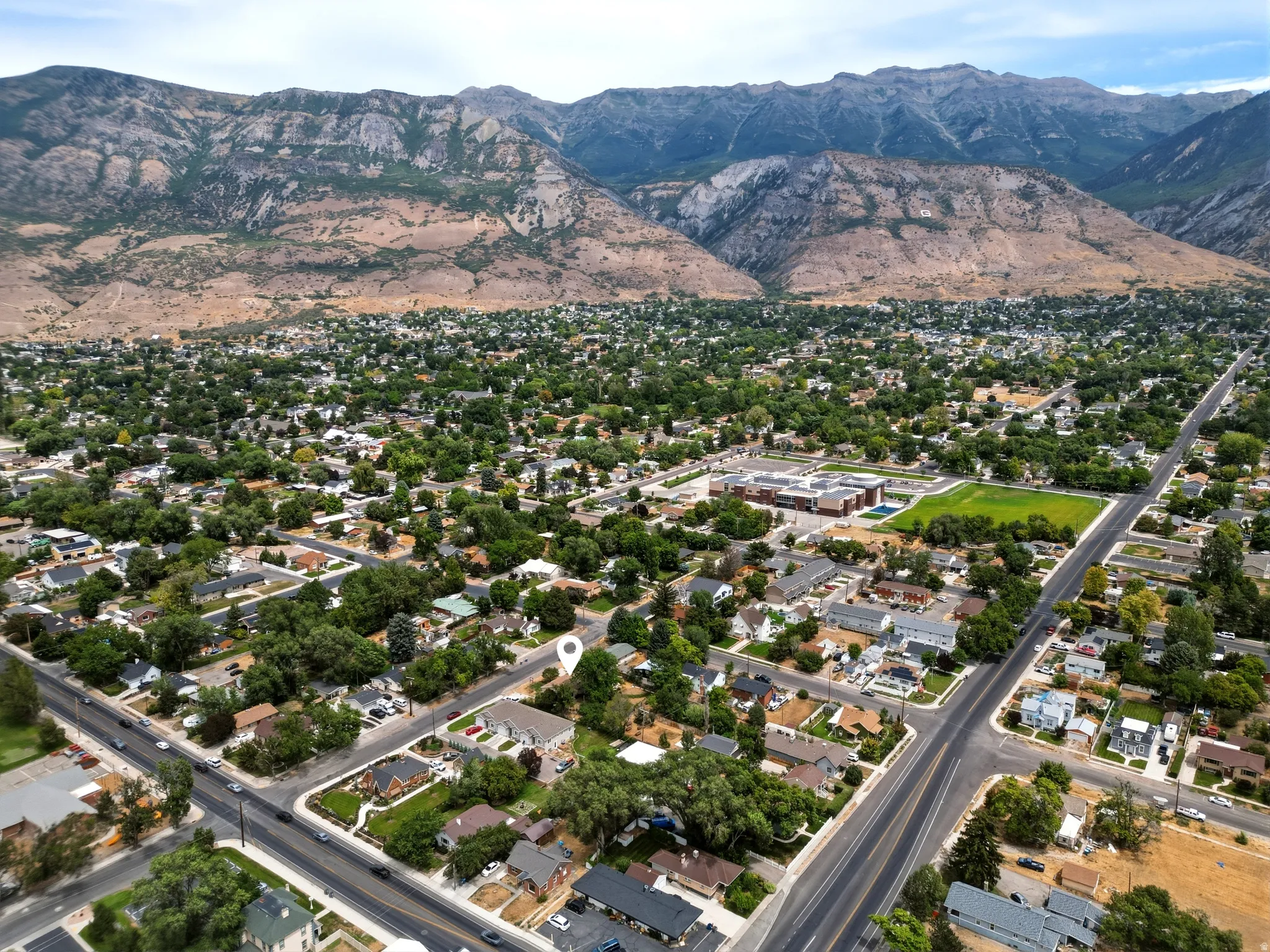 Aerial perspective showcasing a residential area with a prominent mountain backdrop