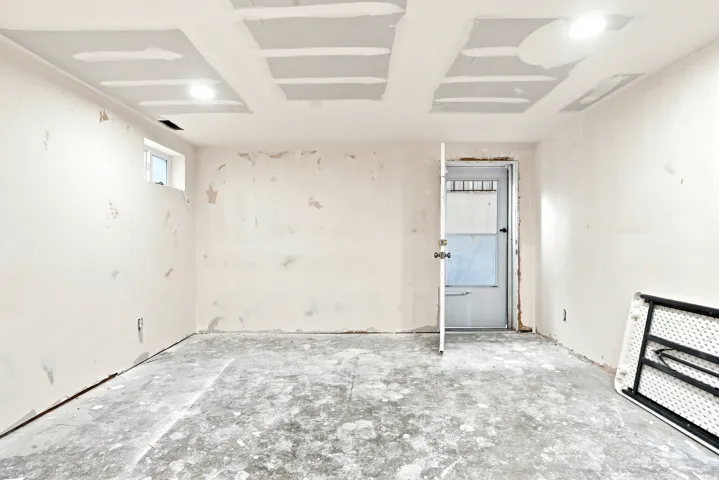 Unfinished interior space with exposed concrete flooring