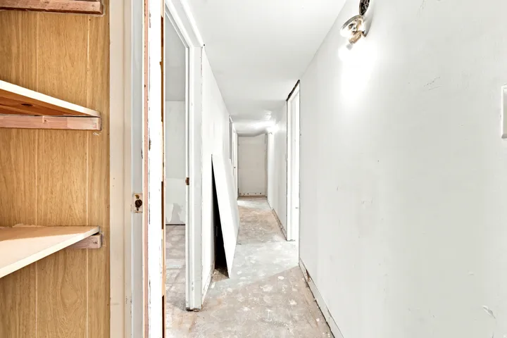 Interior hallway with white painted walls and multiple open doorways