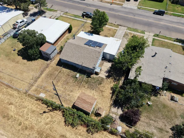 Ranch-style residence featuring a brown shingle roof and solar panels