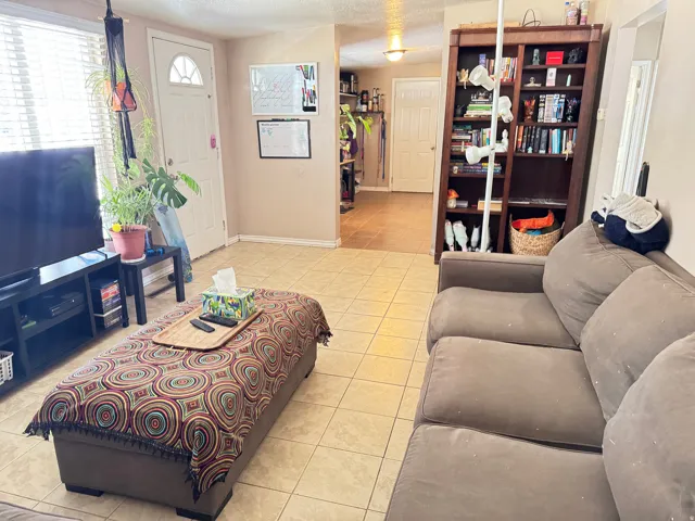 Living area featuring neutral-toned wall paint and light-colored tile flooring
