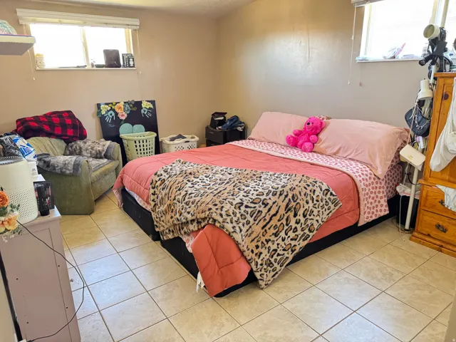 Room featuring light-colored square tile flooring and neutral-toned walls