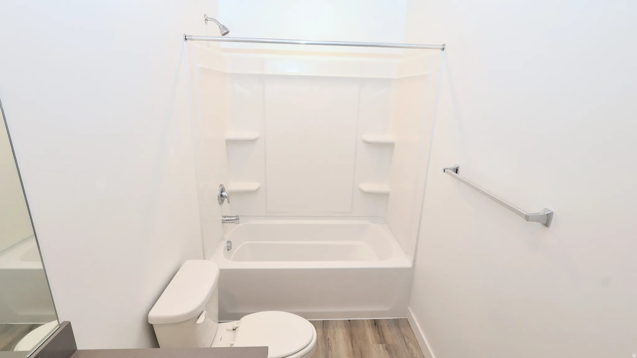Tub and shower combination with chrome fixtures and integrated shelving