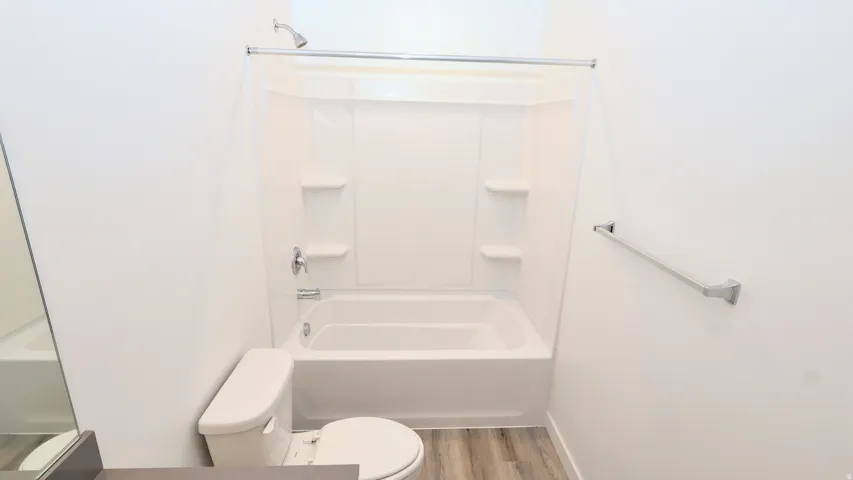 Tub and shower combination with chrome fixtures and integrated shelving