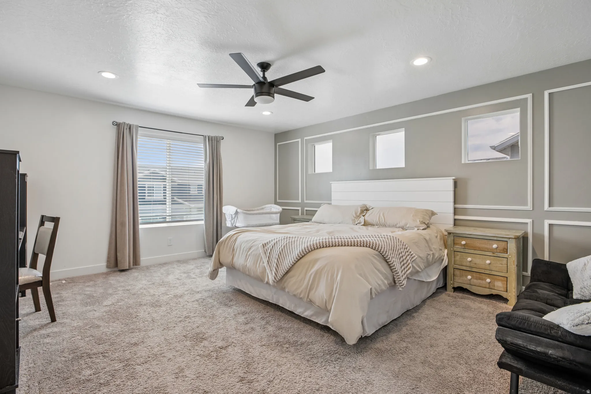 Spacious room featuring carpeting, recessed lighting, and a ceiling fan