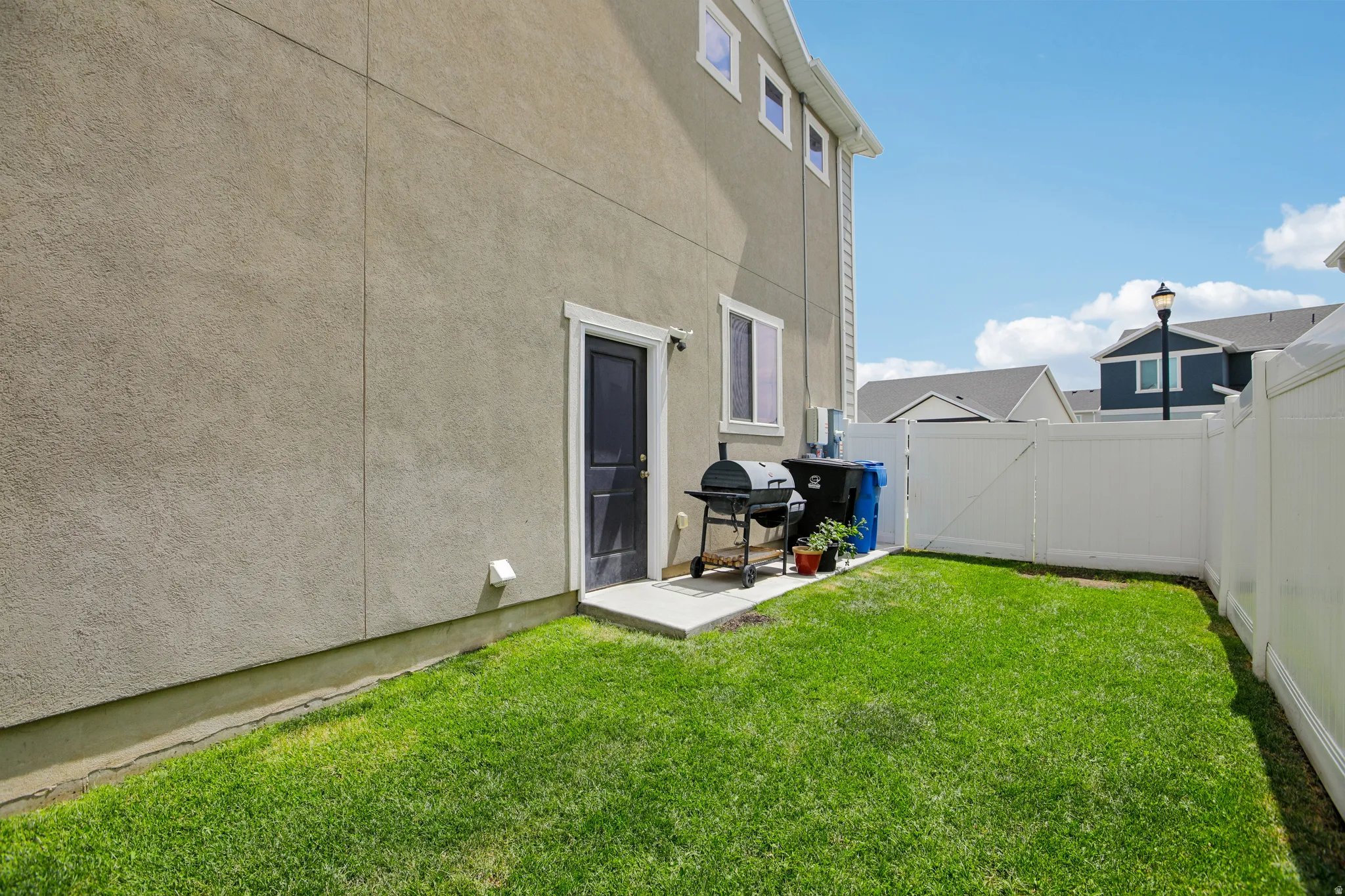 Private outdoor space featuring a lush green lawn