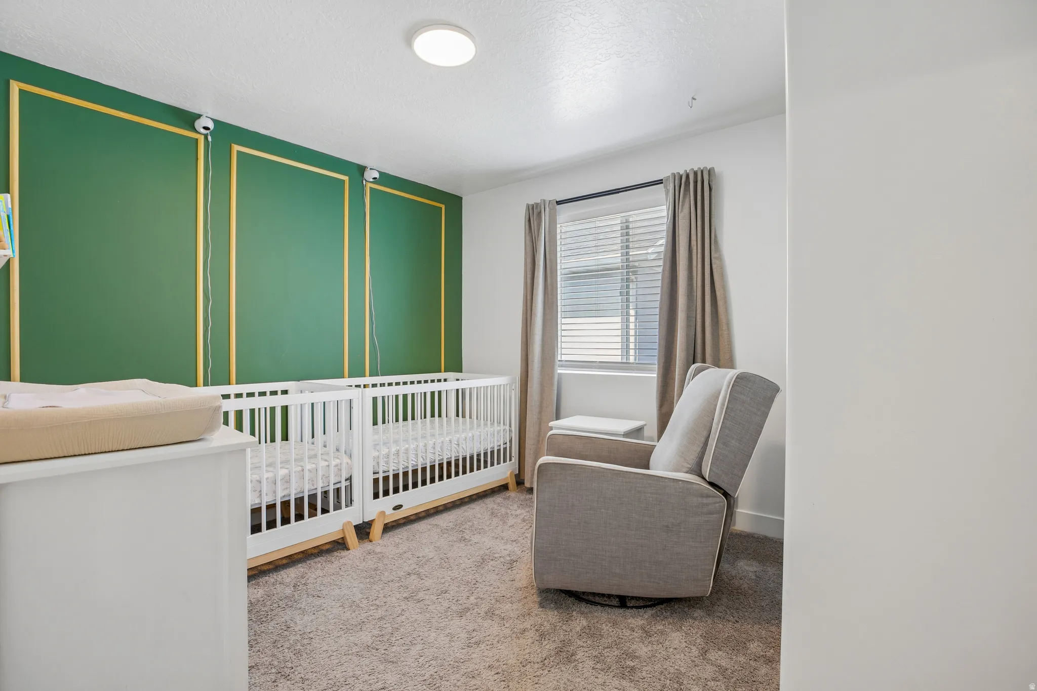 Accent wall with green paint and gold trim detailing