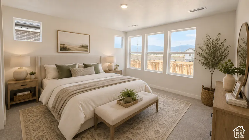 Spacious room with plush carpet flooring, multiple large windows, and an upholstered headboard