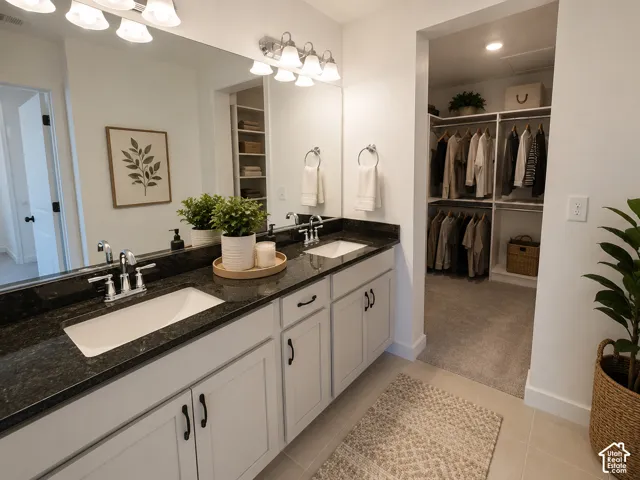 Double vanity with dark stone-finish countertop, dual undermount sinks, and chrome faucets