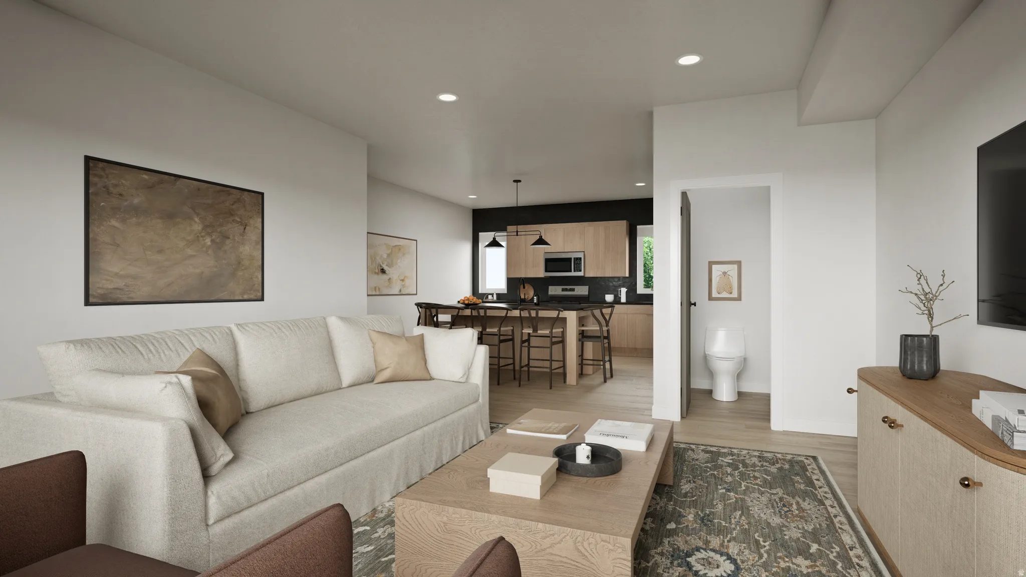 Open-concept living space featuring light wood-finish flooring, recessed lighting, and a neutral color palette