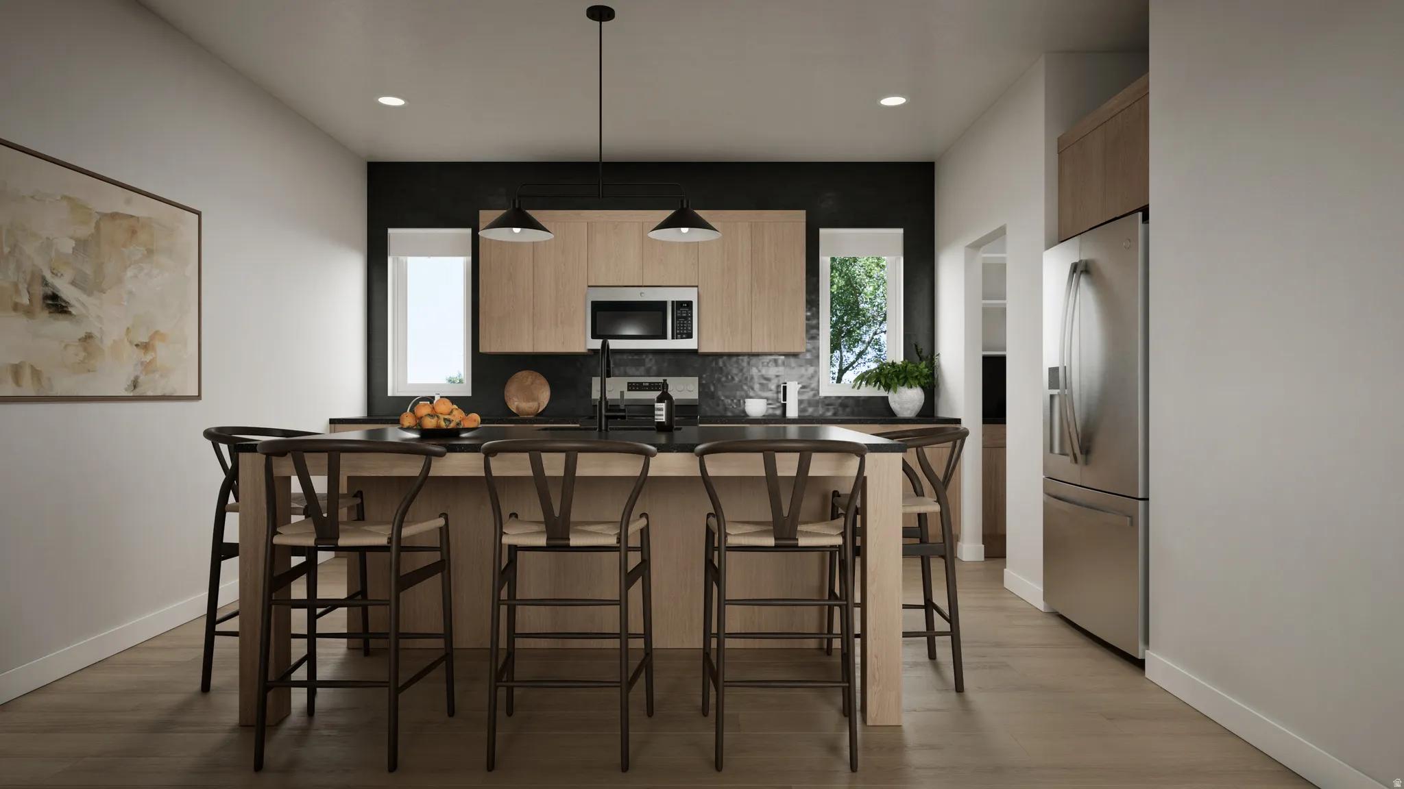 Modern kitchen featuring an expansive center island with seating, stainless steel appliances, light wood-finish cabinetry, and a dark accent wall