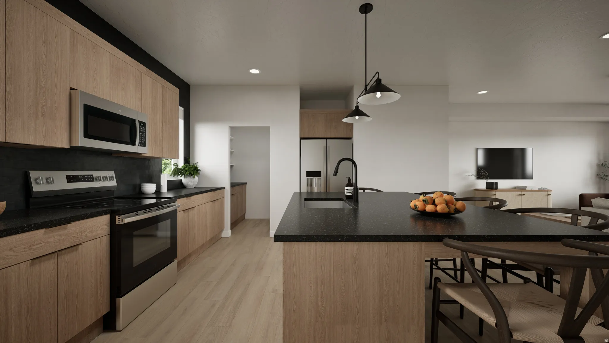 Modern kitchen featuring light wood-finish cabinetry, dark countertops, and stainless steel appliances