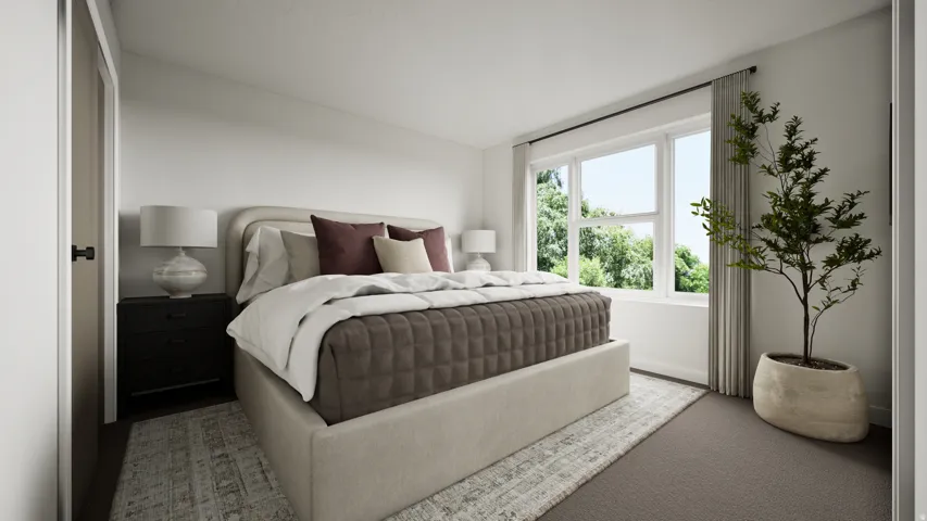 Generous room featuring a large window, light-toned walls, and a combination of patterned area rug and carpet flooring