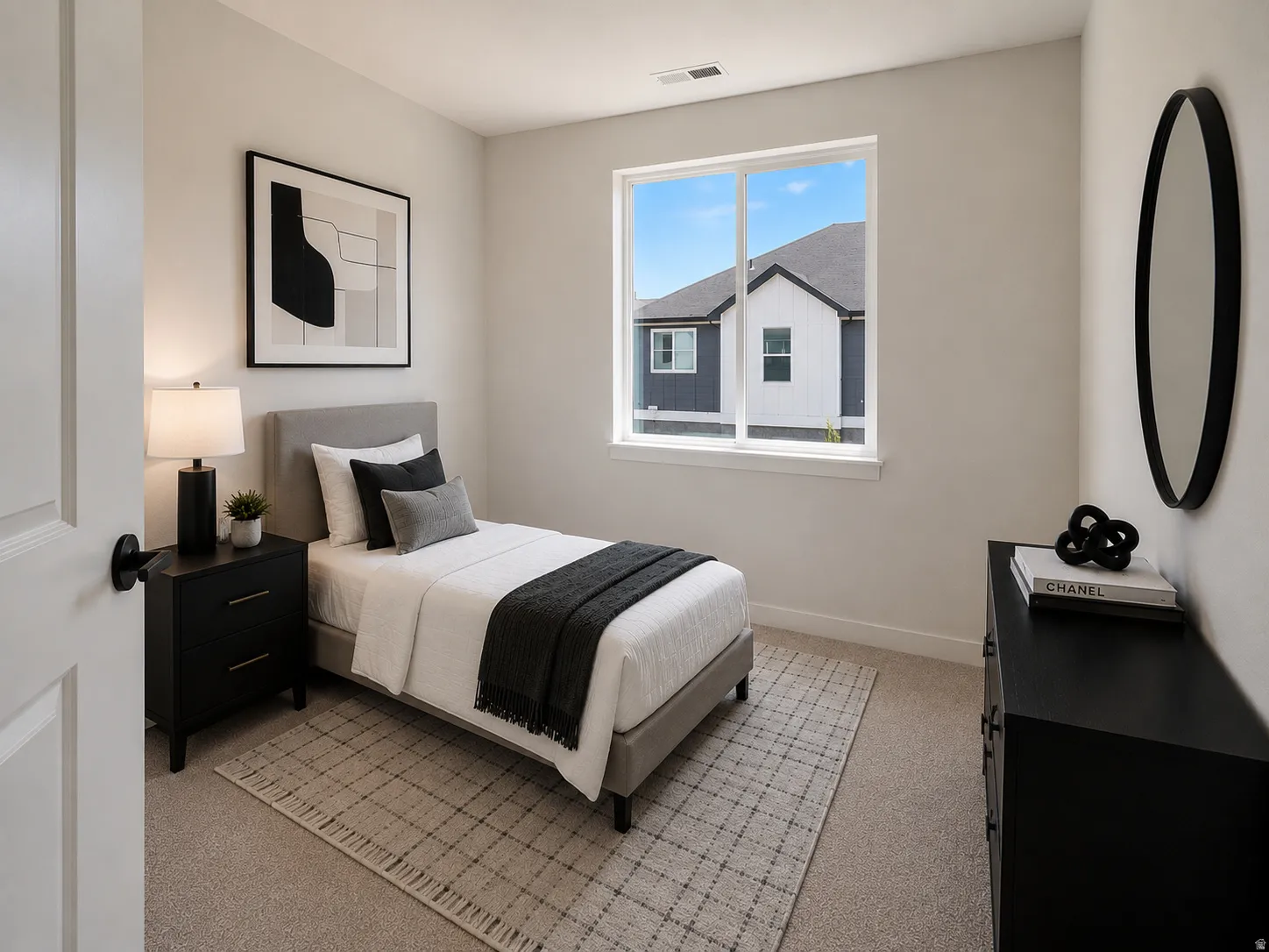 Bedroom featuring light neutral wall paint and carpet flooring