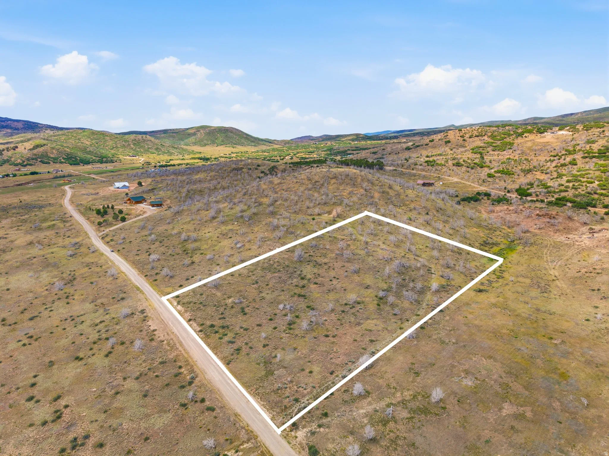 Expansive undeveloped land parcel with a gentle slope and natural vegetation