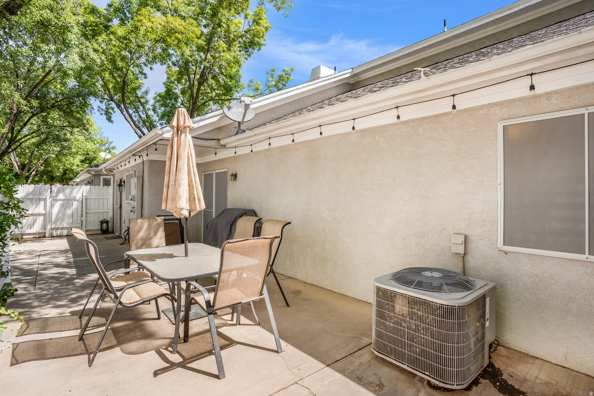 Private patio space featuring a concrete slab and a stucco exterior