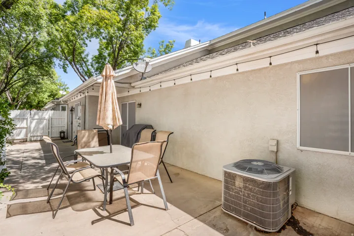 Private patio space featuring a concrete slab and a stucco exterior