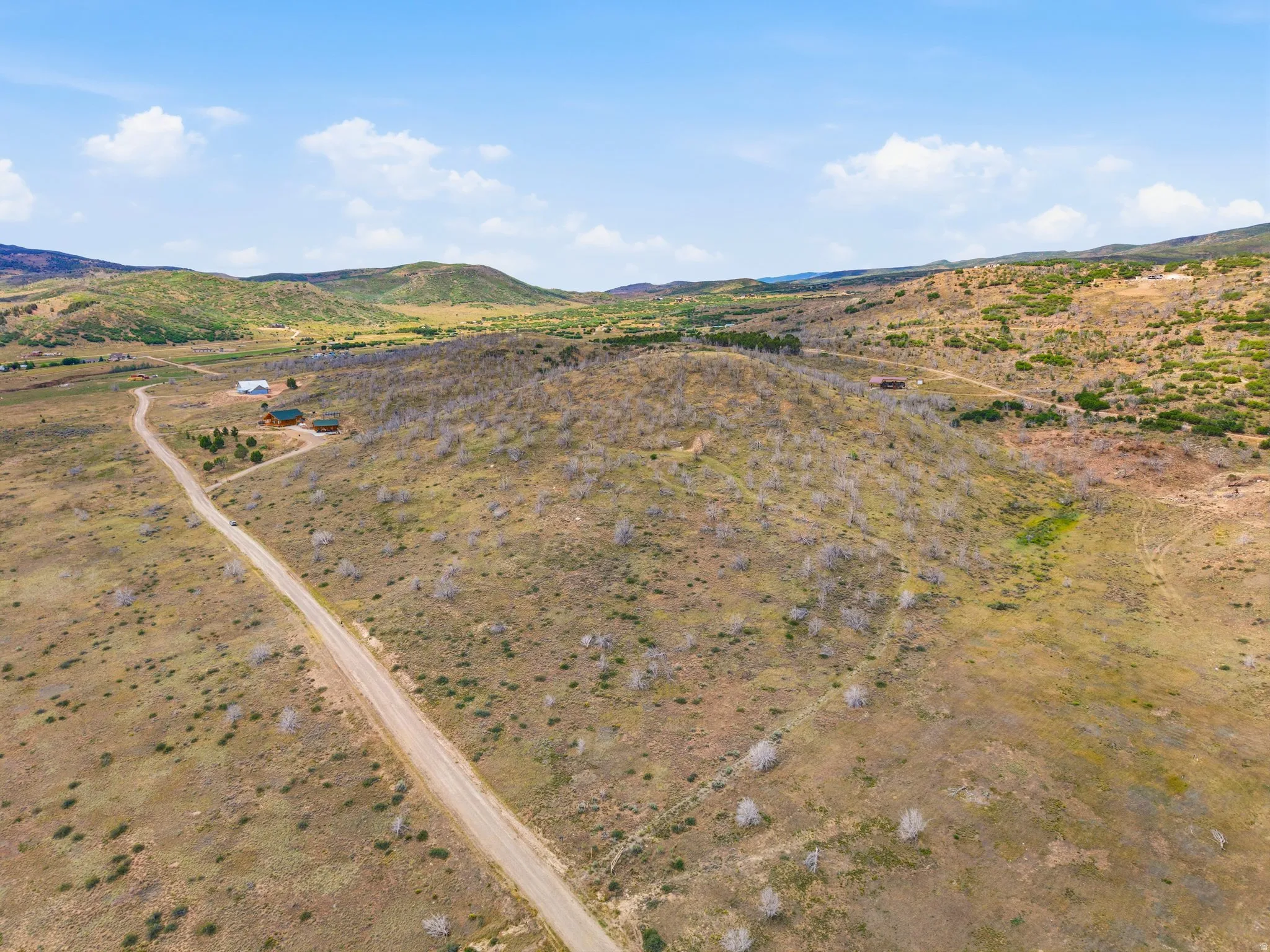 Extensive acreage featuring natural terrain and distant mountains