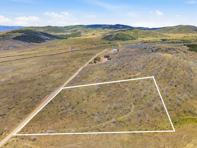 Expansive parcel of land with varied topography, including a gently sloping hillside