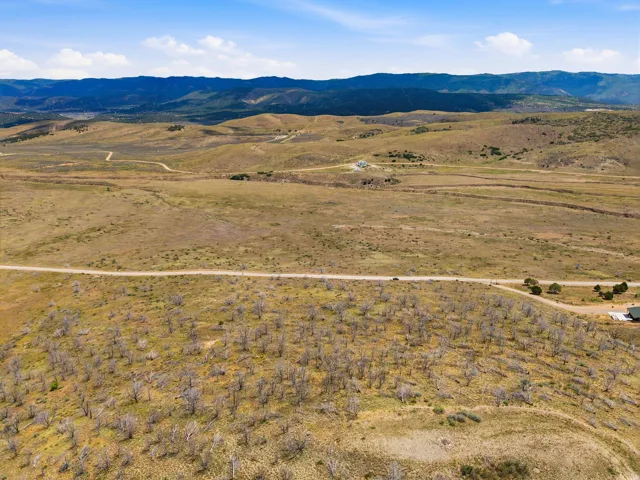 Expansive open acreage featuring a natural landscape and distant mountain ranges