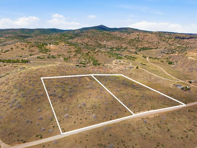 Expansive land parcel featuring a natural, undeveloped landscape with scattered vegetation