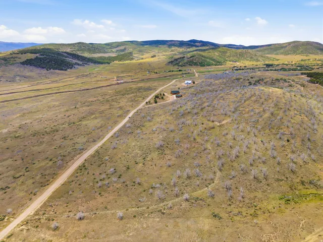 Expansive rural landscape featuring rolling hills and distant mountains